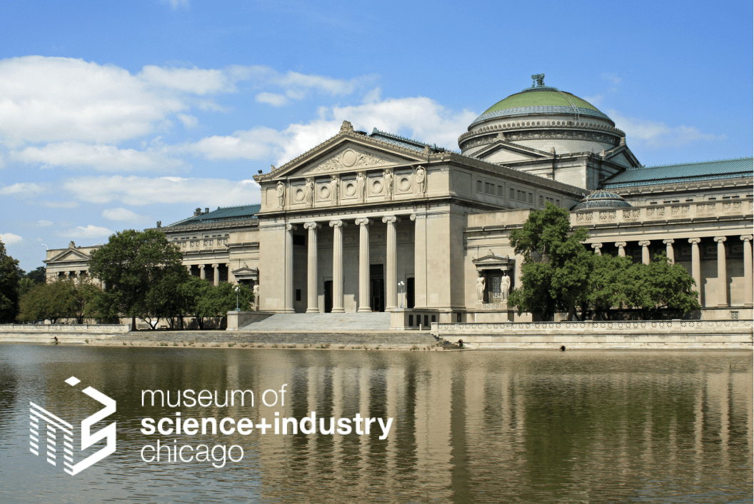 A large museum in front of a body of water